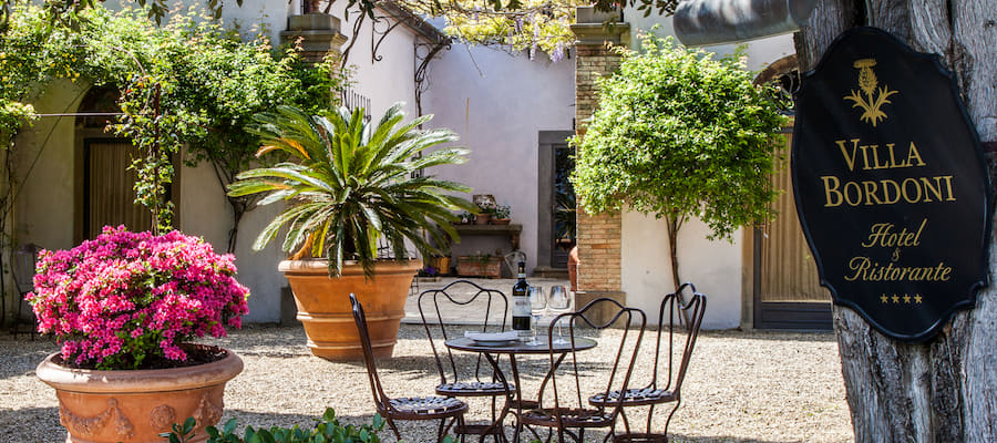 Hotel Villa Bordoni entrance courtyard with garden and sign